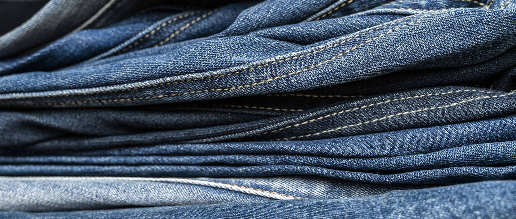 stack-of-tall-blue-jeans