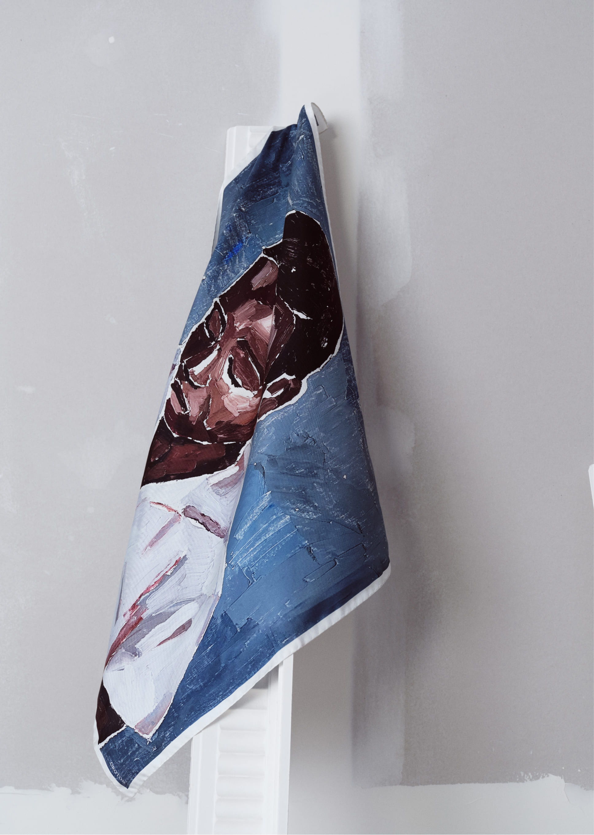 A towel featuring a painted portrait of a man.