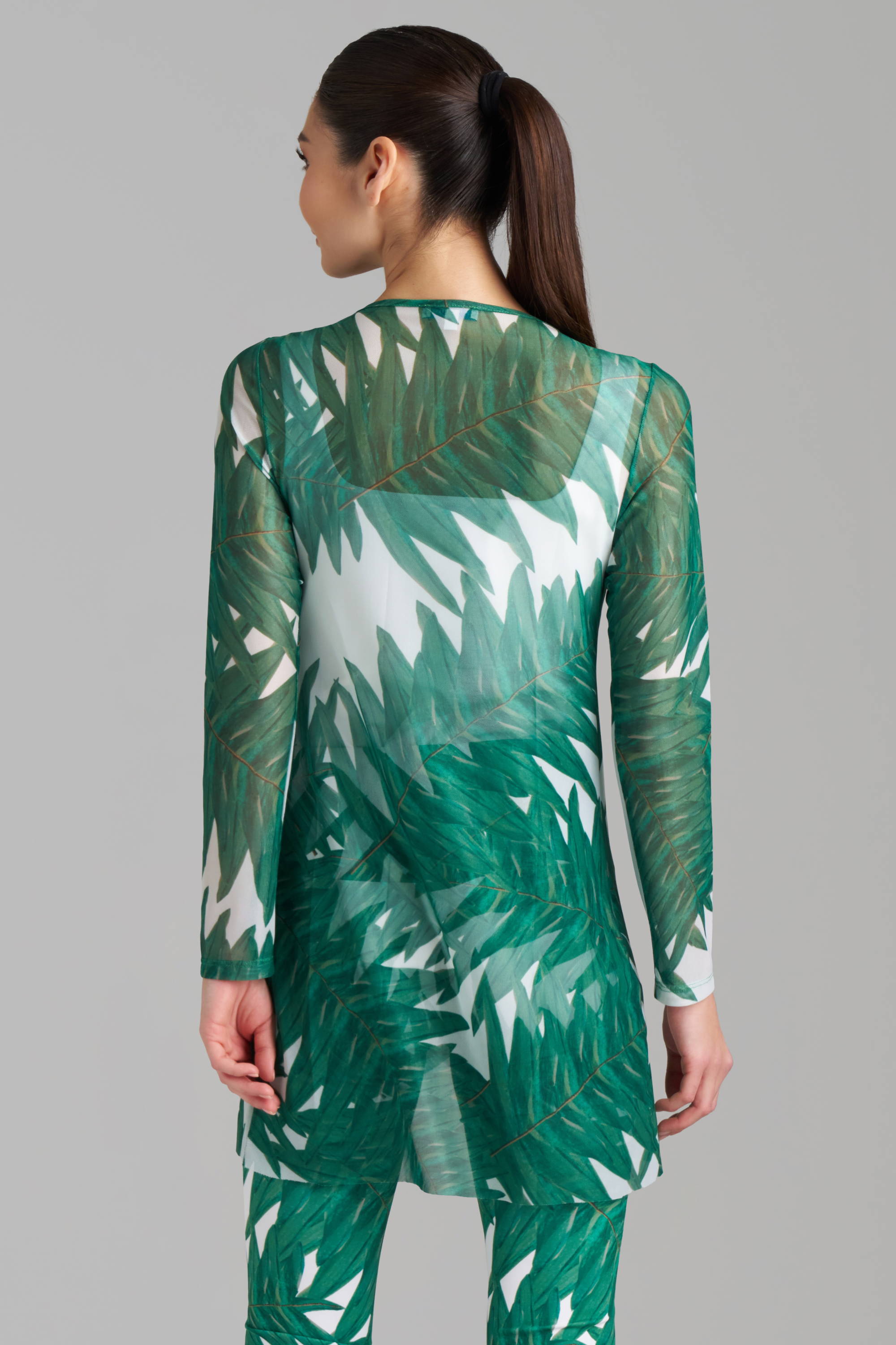 Woman wearing green palm printed mesh tunic by Ala von Auersperg
