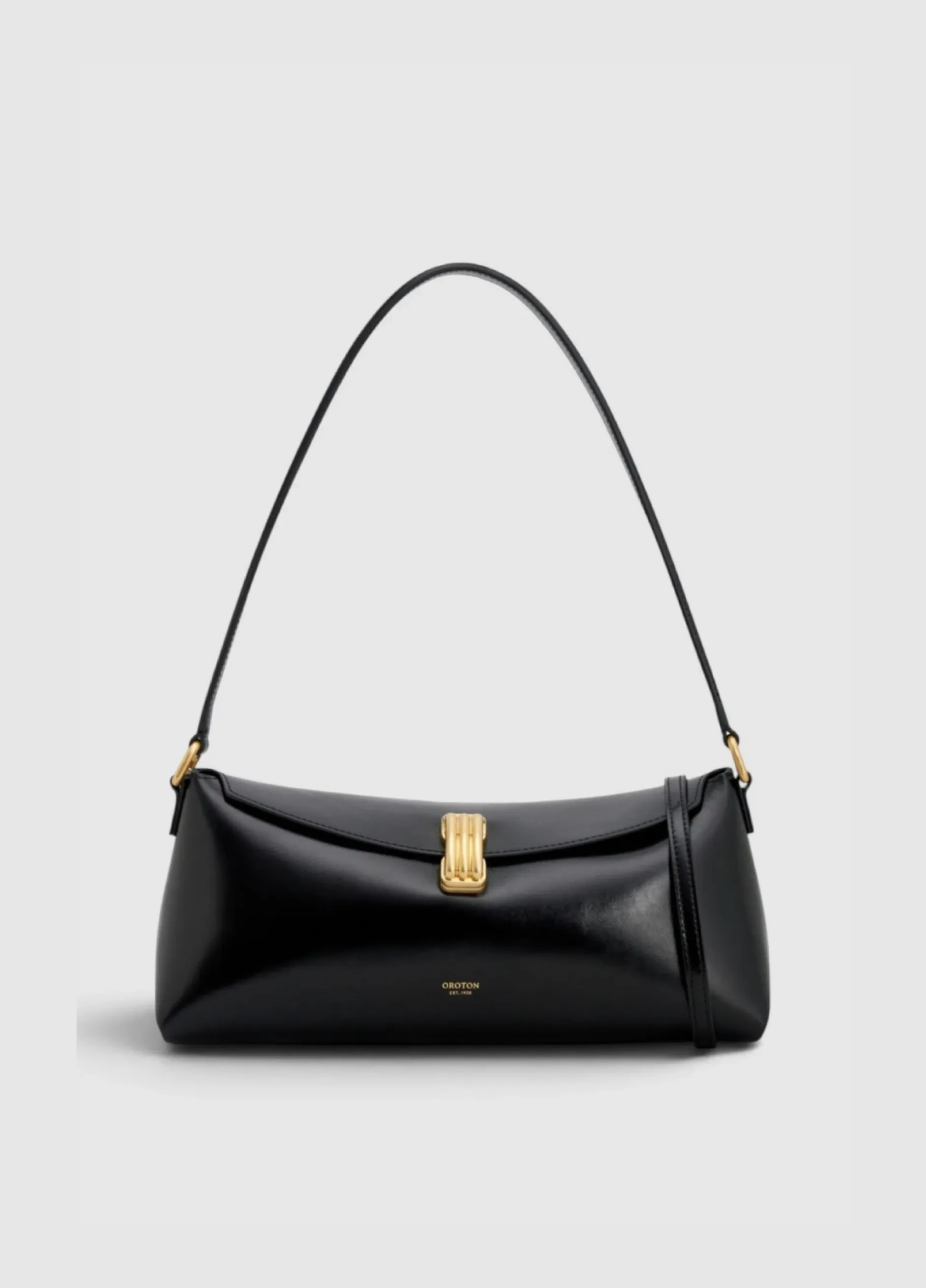 Black handbag with a curved strap and gold clasp detail.