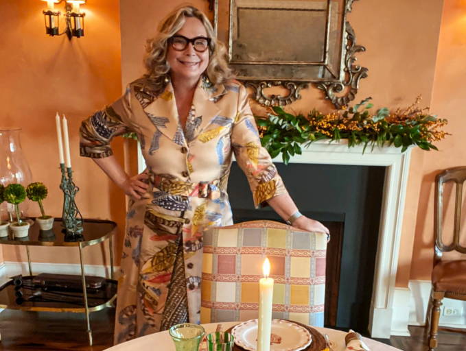 Ala Isham wearing feather printed silk jacket at a table setting by Ala von Auersperg