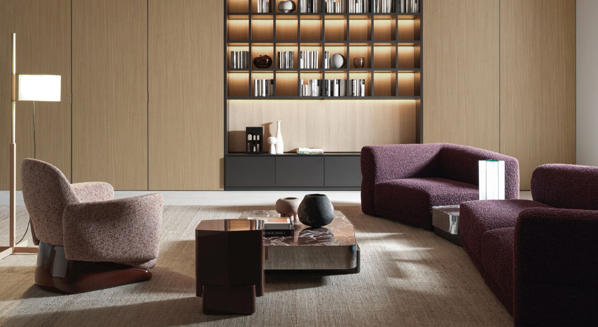 Modern living room with purple furniture and a stylish bookshelf.