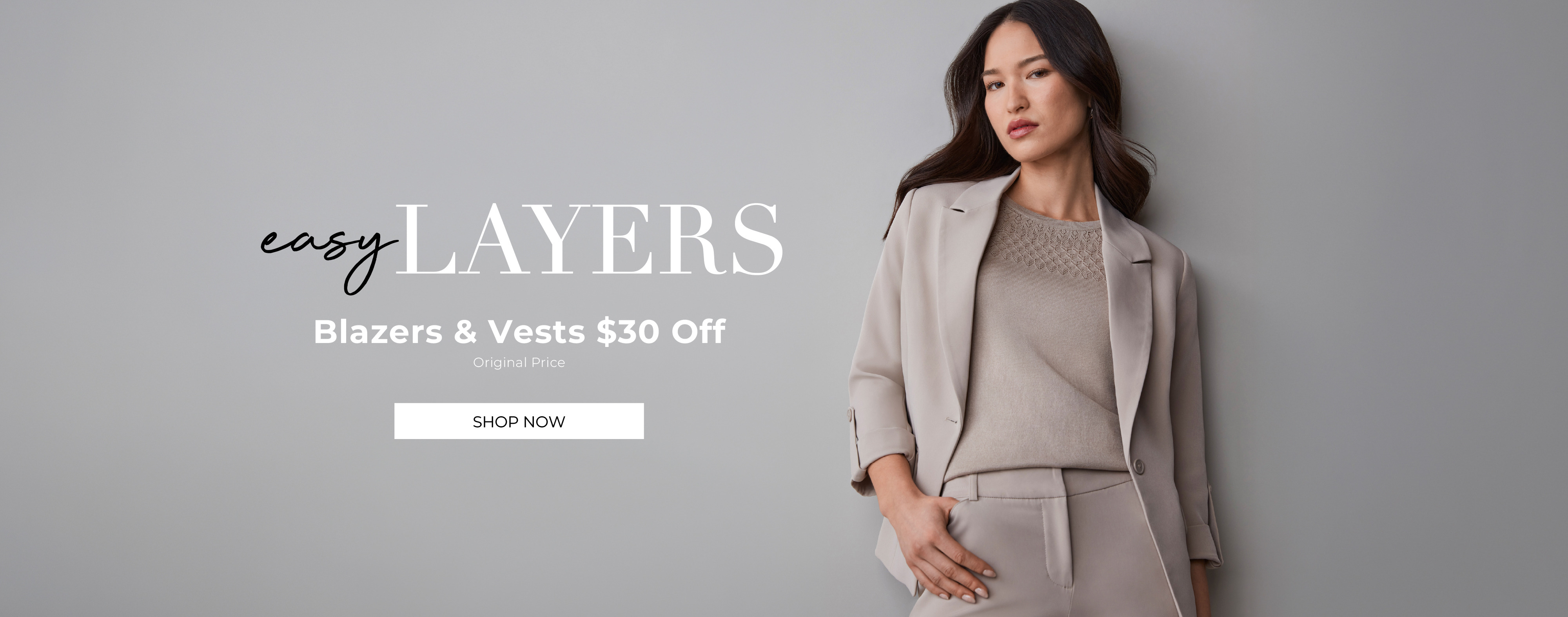Woman in stylish outfit against a gray background promoting discounts on layers.