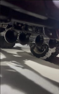 Four train horn trumpets on Tanner's Ford F-150 undercarriage covered in snow at night