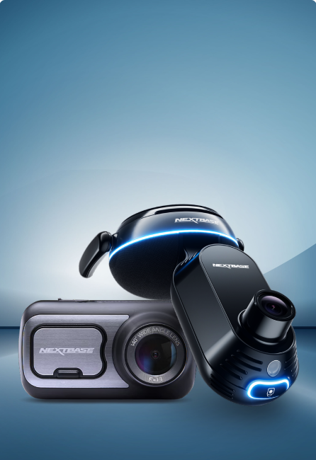 Three Nextbase dash cameras against a gradient blue background.