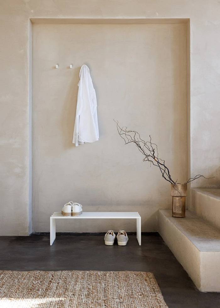 Hallway design with white coat hooks and white shoe rack | metal booth