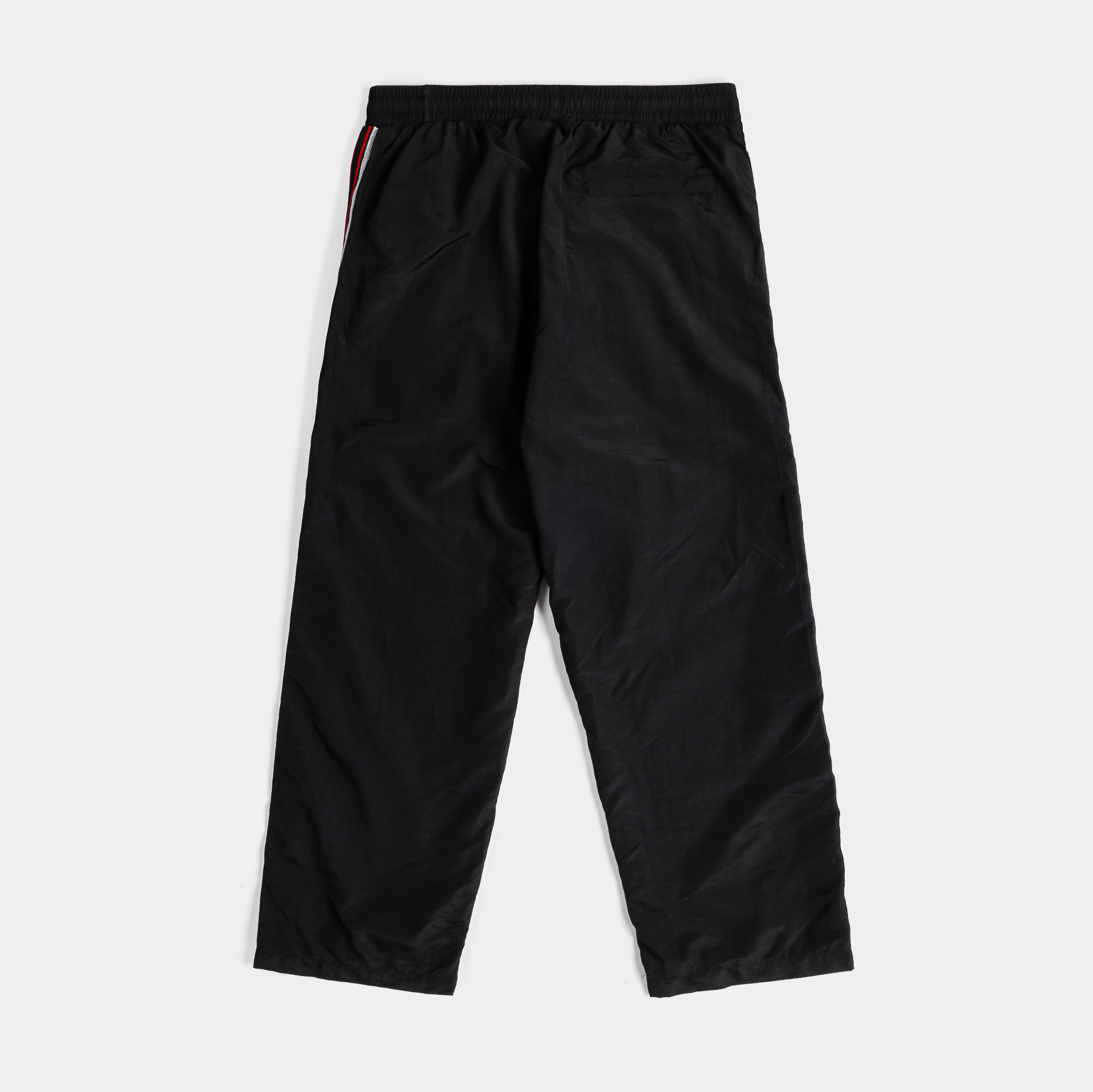 Black athletic pants with red and white side stripes and logo.