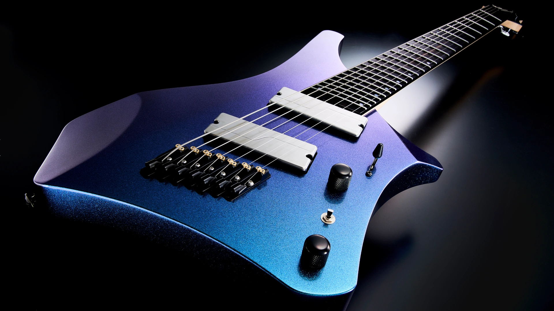 A blue Ibanez Alpha Series electric guitar lying on a dark surface.