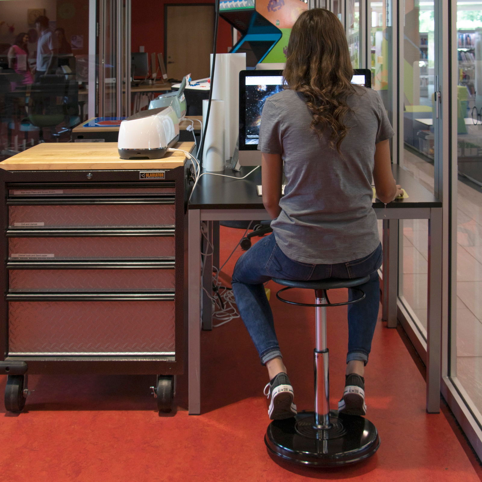 Teen girl sitting on a black adjustable wobble stool