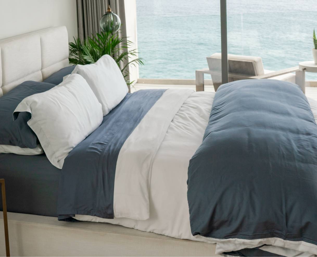 bed with duvet cover and sheets