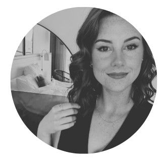 A woman with curly hair, smiling, in a circular frame.