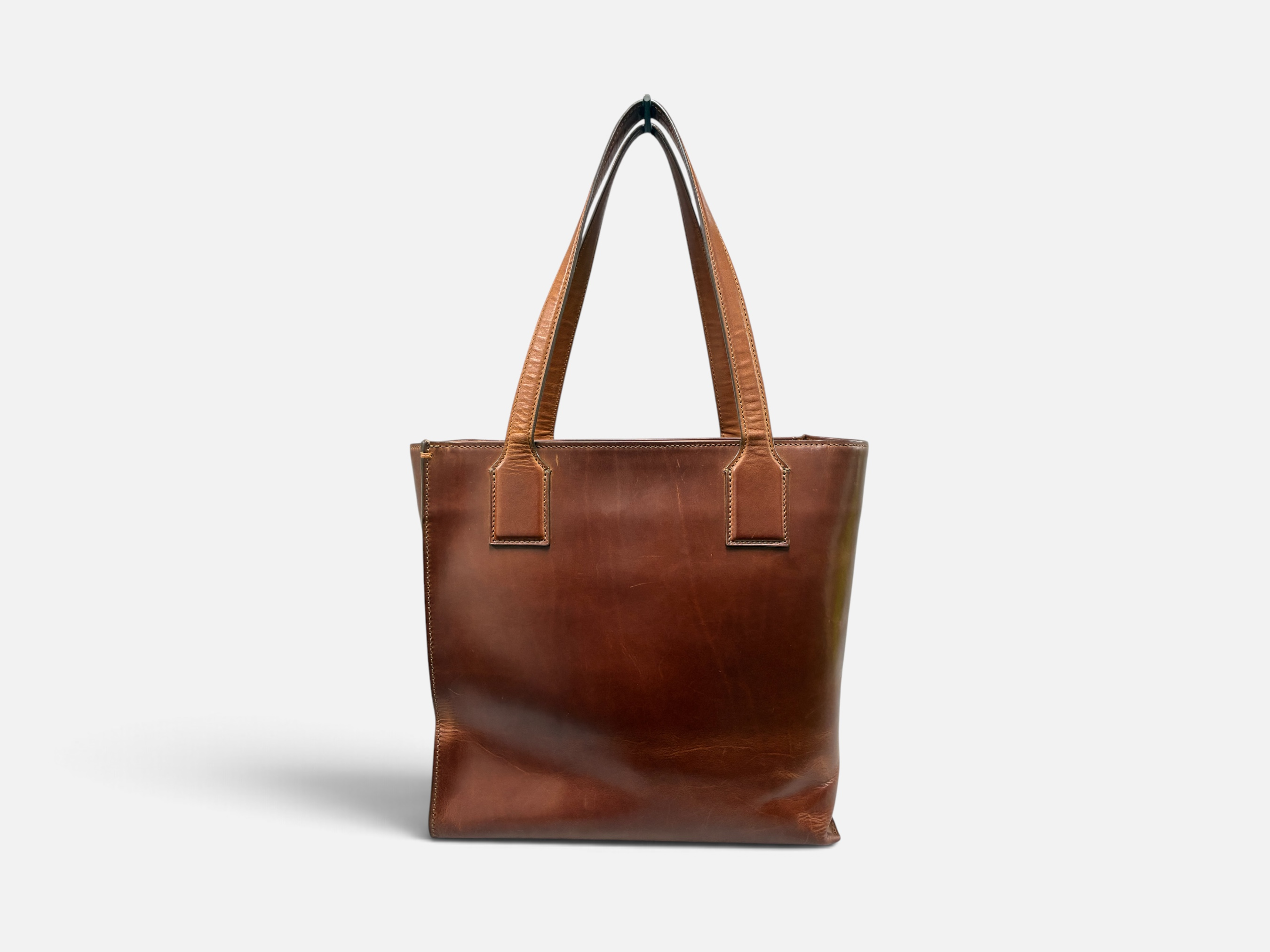 Brown leather tote bag with two handles.