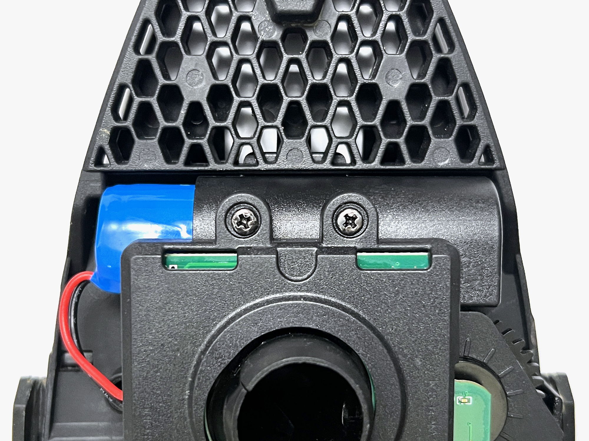 Close-up of a black plastic DRV tray with hexagonal pattern and colorful components.