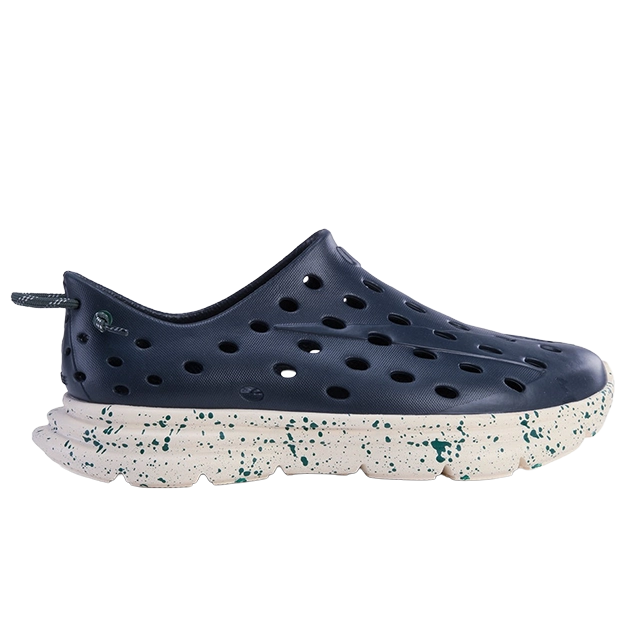 Navy blue slip-on shoe with holes and a speckled white sole.
