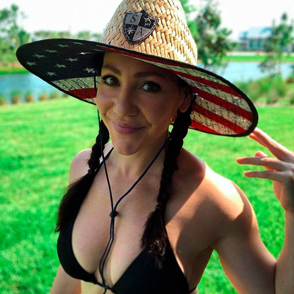 Michelle Paula wearing an SA Company straw hat with the American flag design in the under brim. Smiling at the camera.