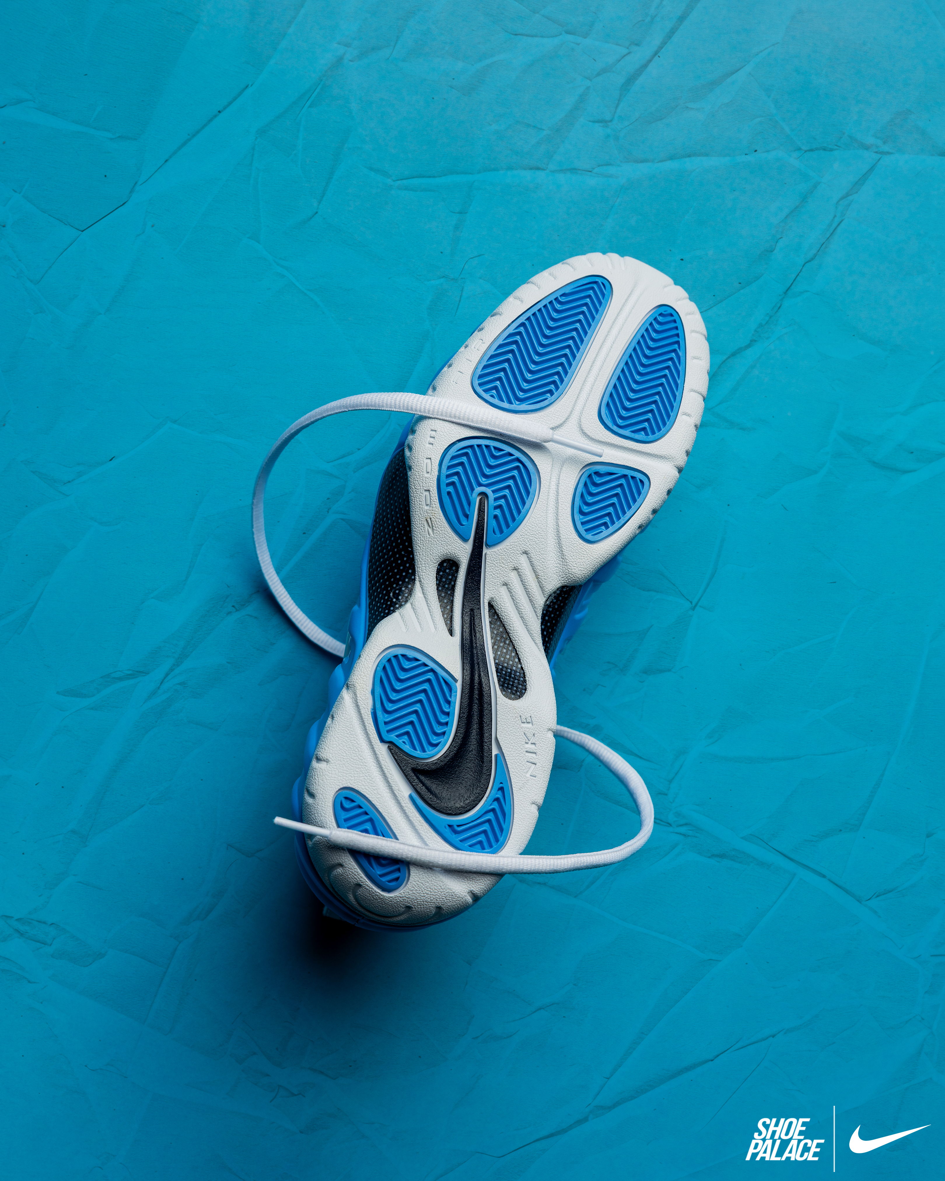 A pair of Nike shoes on a blue background.