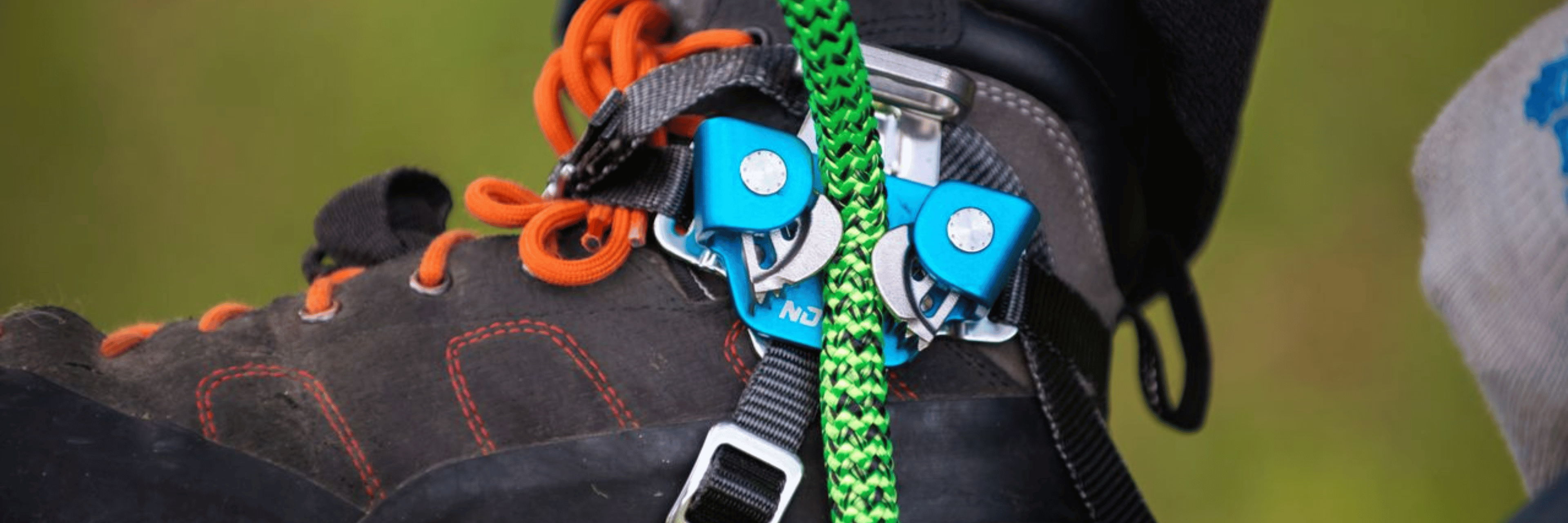 Close-up of a boot with climbing gear attached.