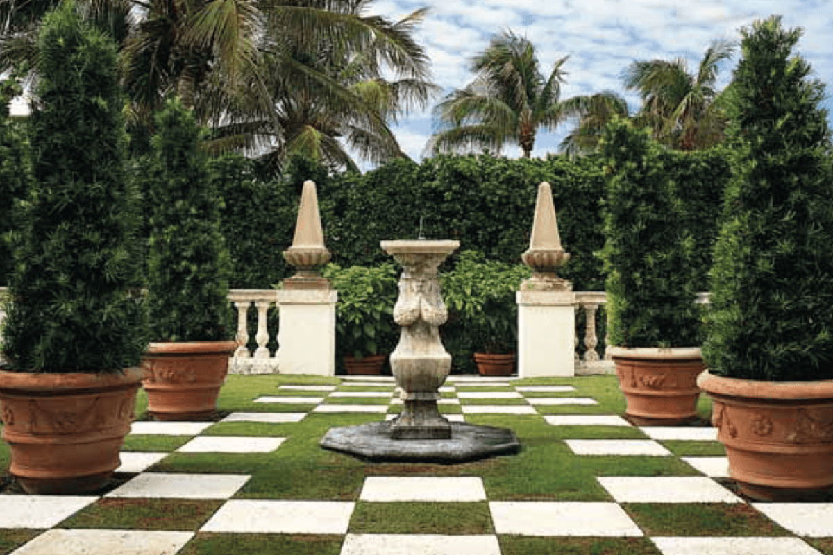 Large heirloom-quality terracotta planters and formal garden fountain showing durable outdoor accessories in a designed landscape.