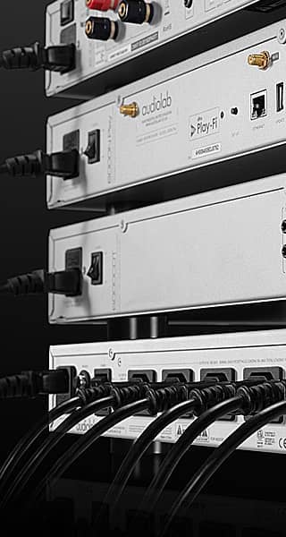 Stacked audio equipment with various inputs and outputs visible.