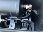Close-up of HornBlasters air tank and compressor with braided air lines and brass fittings