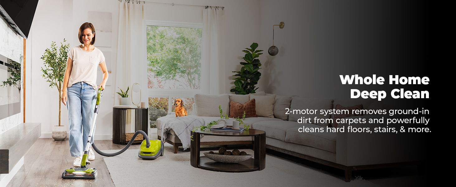 Woman using a vacuum cleaner in a modern living room.