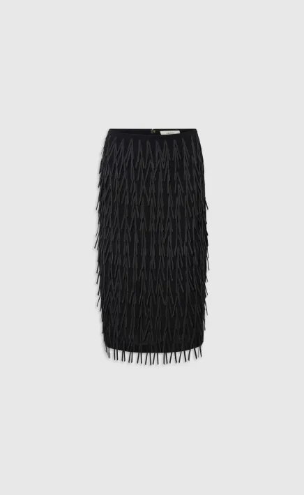 Black fringe skirt on a plain background.