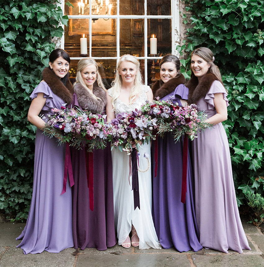 Matching bridesmaids dresses in shades of purple
