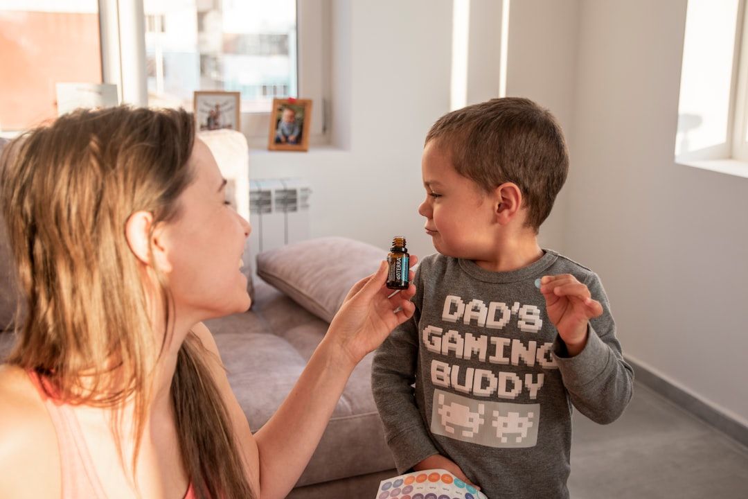 a woman is playing with a small boy