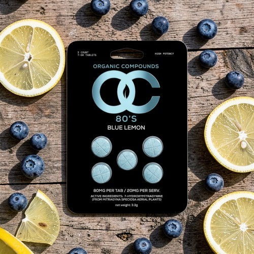 Organic candy package with blueberries and lemon slices on a wooden surface.