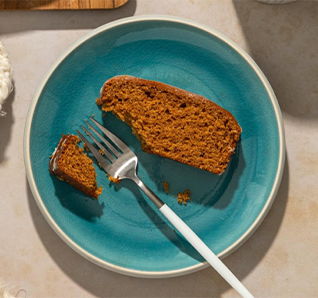 Slice of spiced loaf cake on a blue plate with a fork. | View this post on Tastefully Simple's Instagram. 