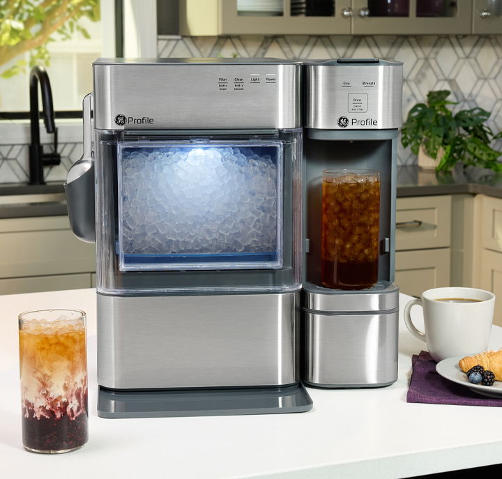 Modern beverage maker with iced tea and coffee on a kitchen counter.