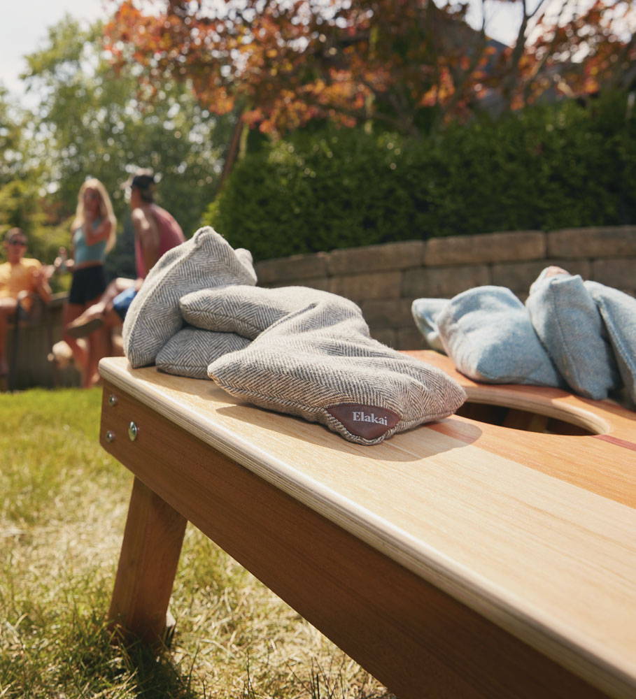 Printed cornhole board with herringbone wool cornhole bags