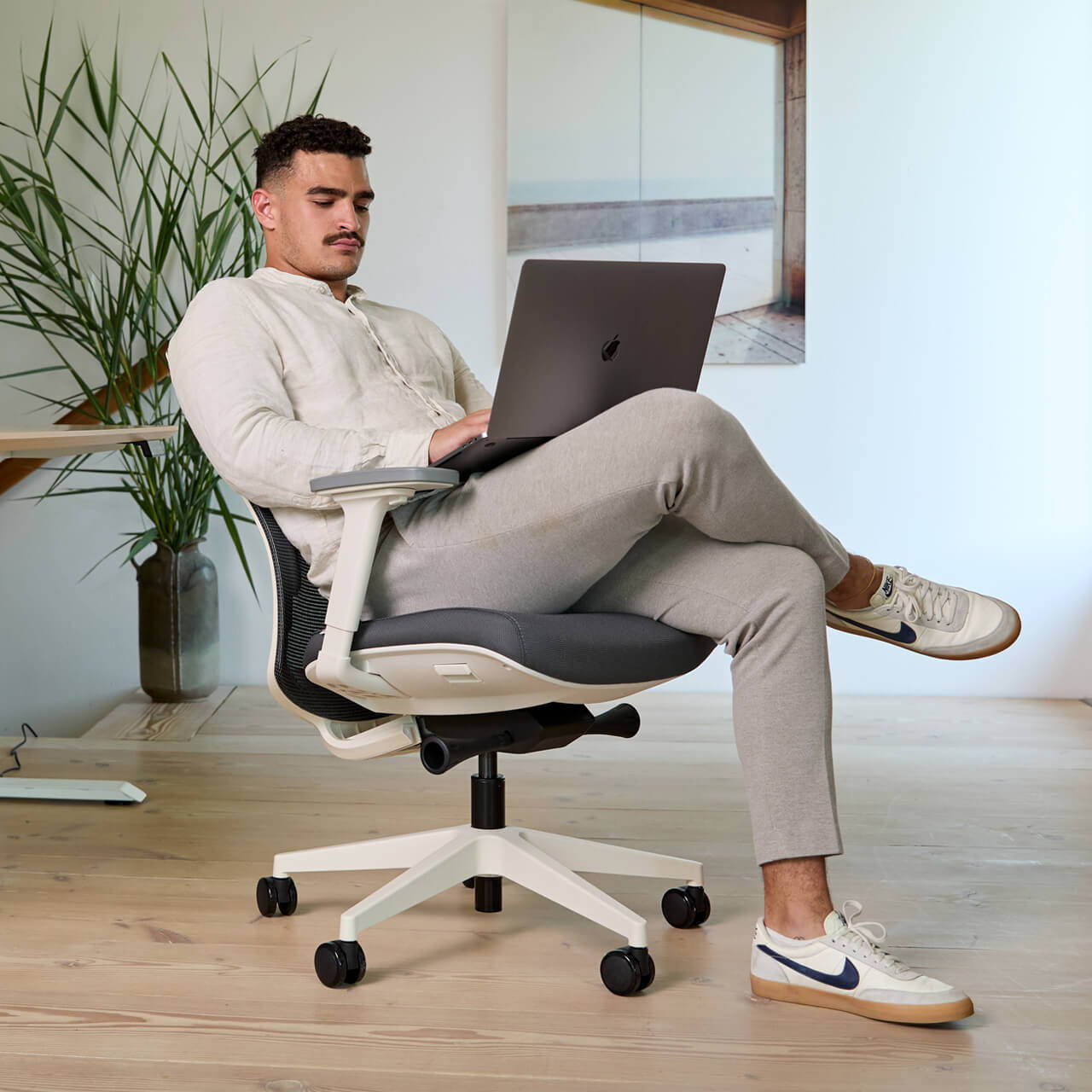 A man working from home at an ofinto Ergo desk