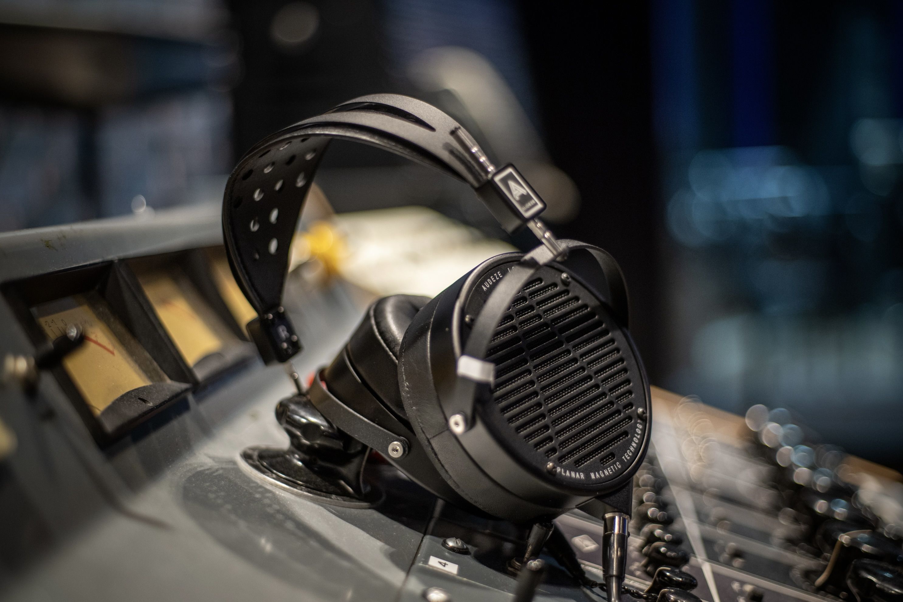 Audeze LCD-X headphones laying on mixing console in the studio 