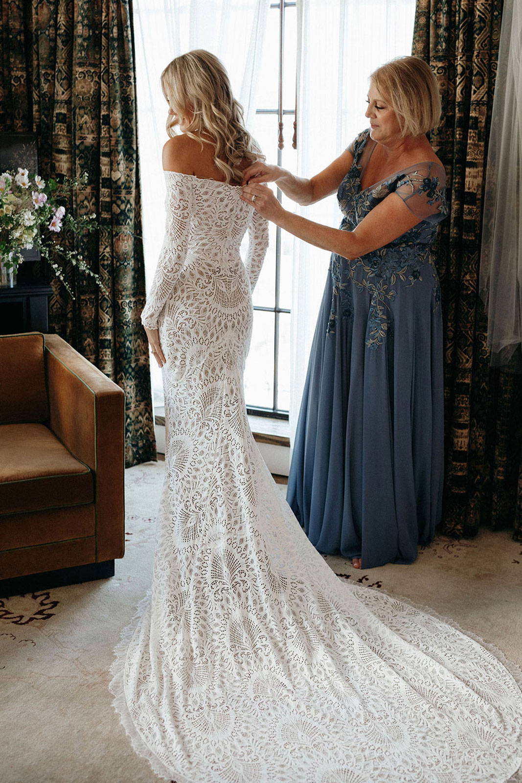 Mother of the Bride helping Bride button the Nathalia gown