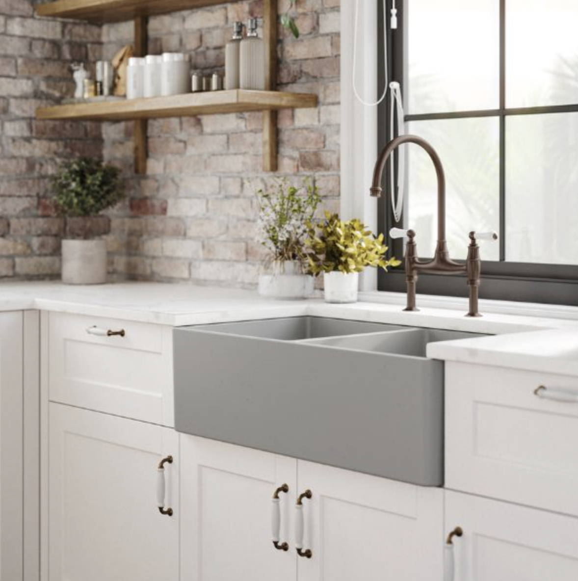 Rustic kitchen with exposed brick, white cabinetry, farmhouse style sink and traditional cabinet handles 