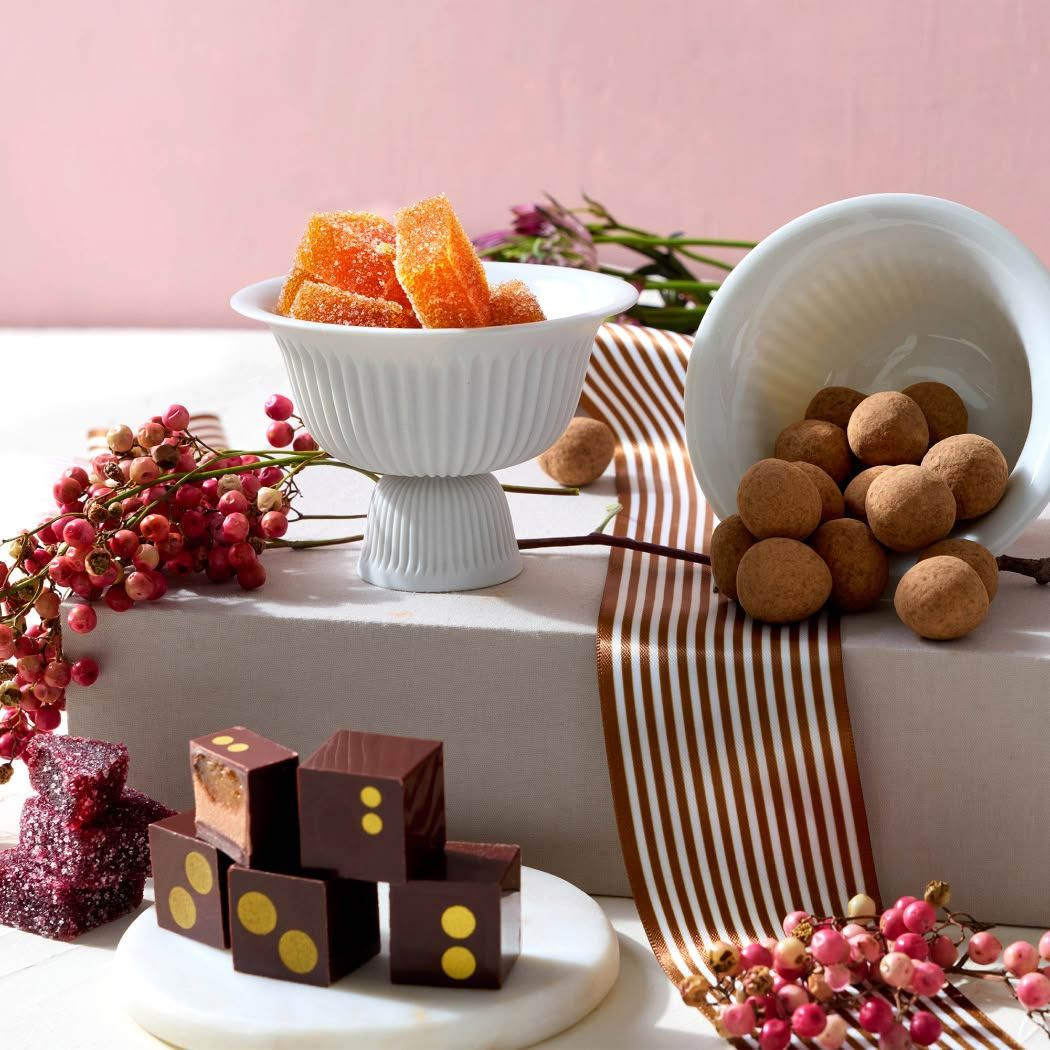 Desserts displayed on a white surface with decorative elements.