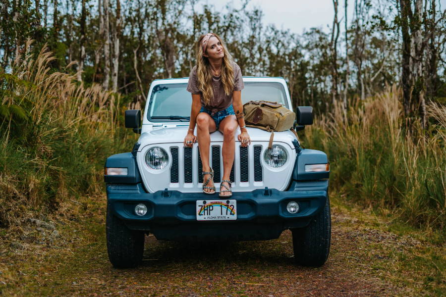 woman with adjustable sandals sitting on car