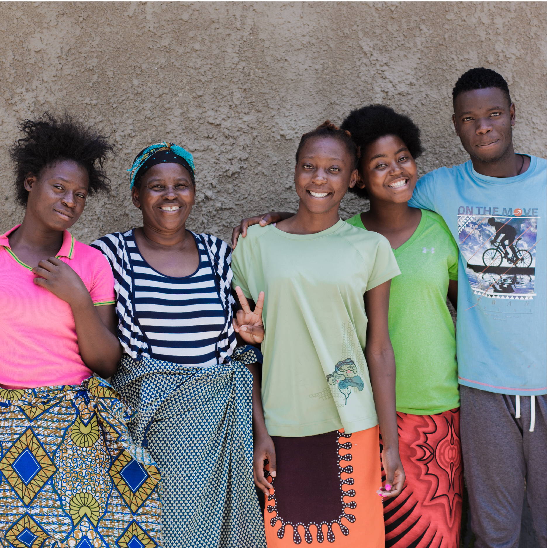 A group of Zambian teenagers stand with their house mom at one of the My Fathers House Children's Homes in Lusaka Zambia 