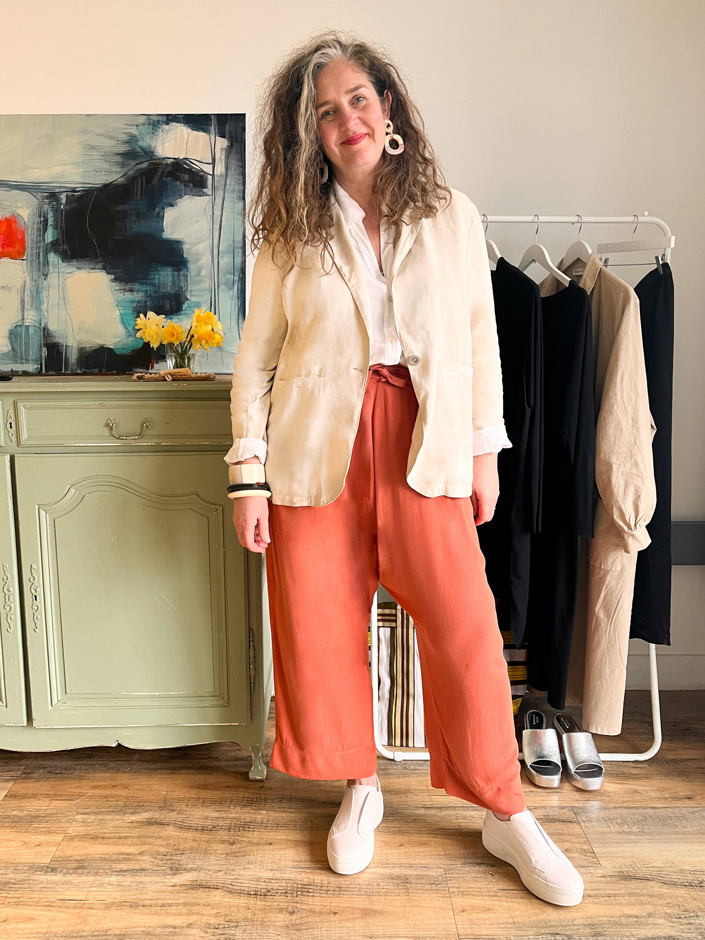 Emma wearing a cream jacket and terracotta drop-crotch trousers