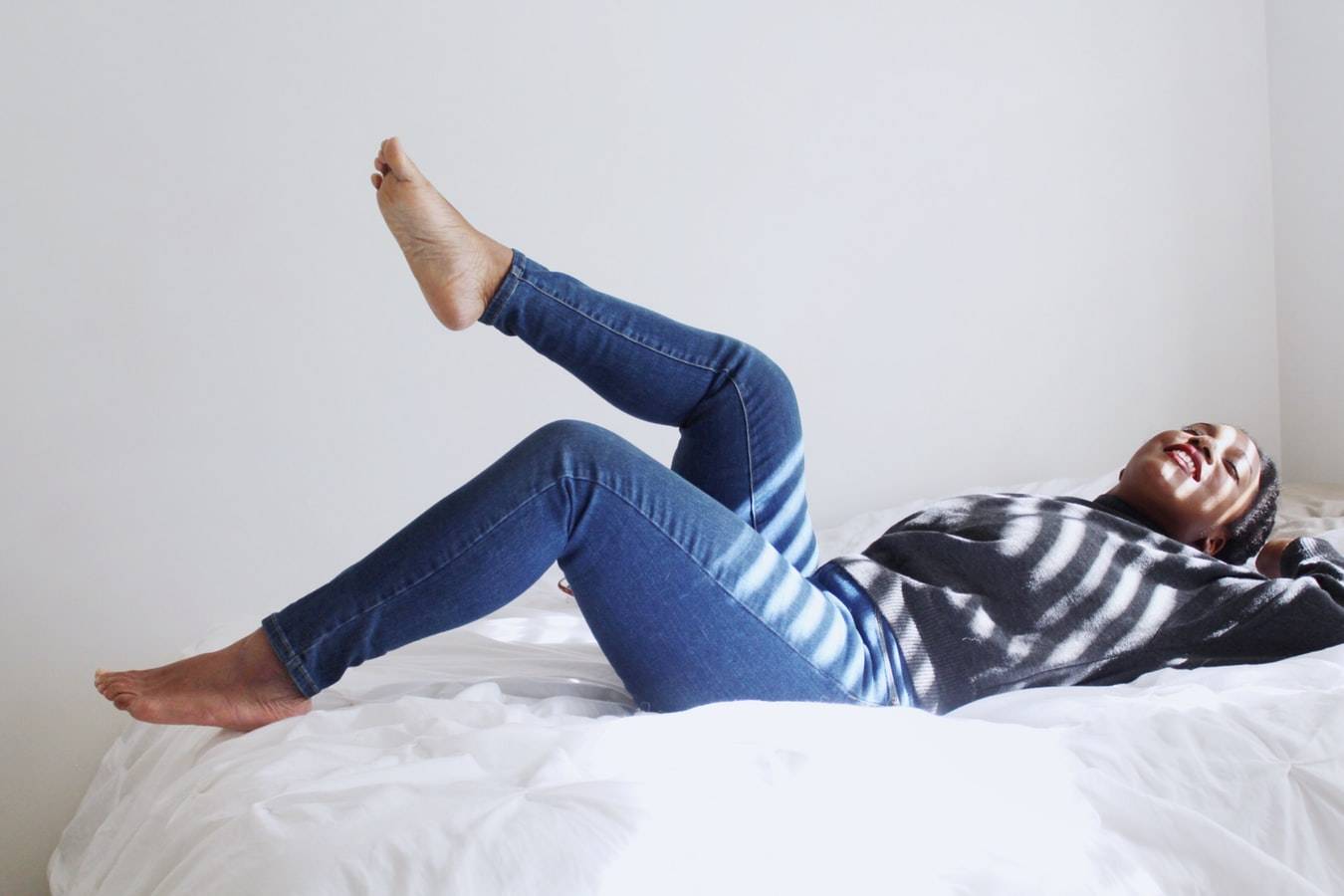 Woman Laying On White Bed