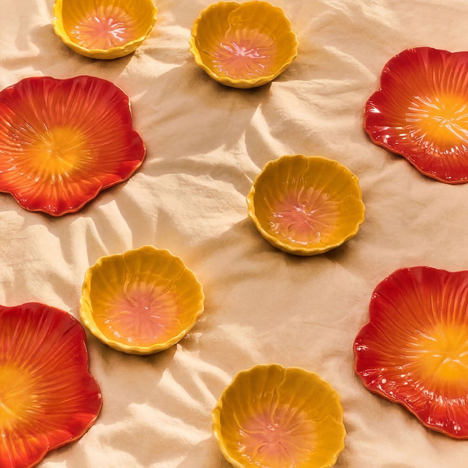 Colorful decorative bowls arranged on a soft beige surface.