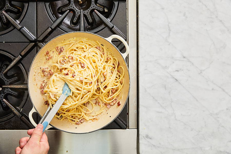 Pasta stirred with pancetta and sauce