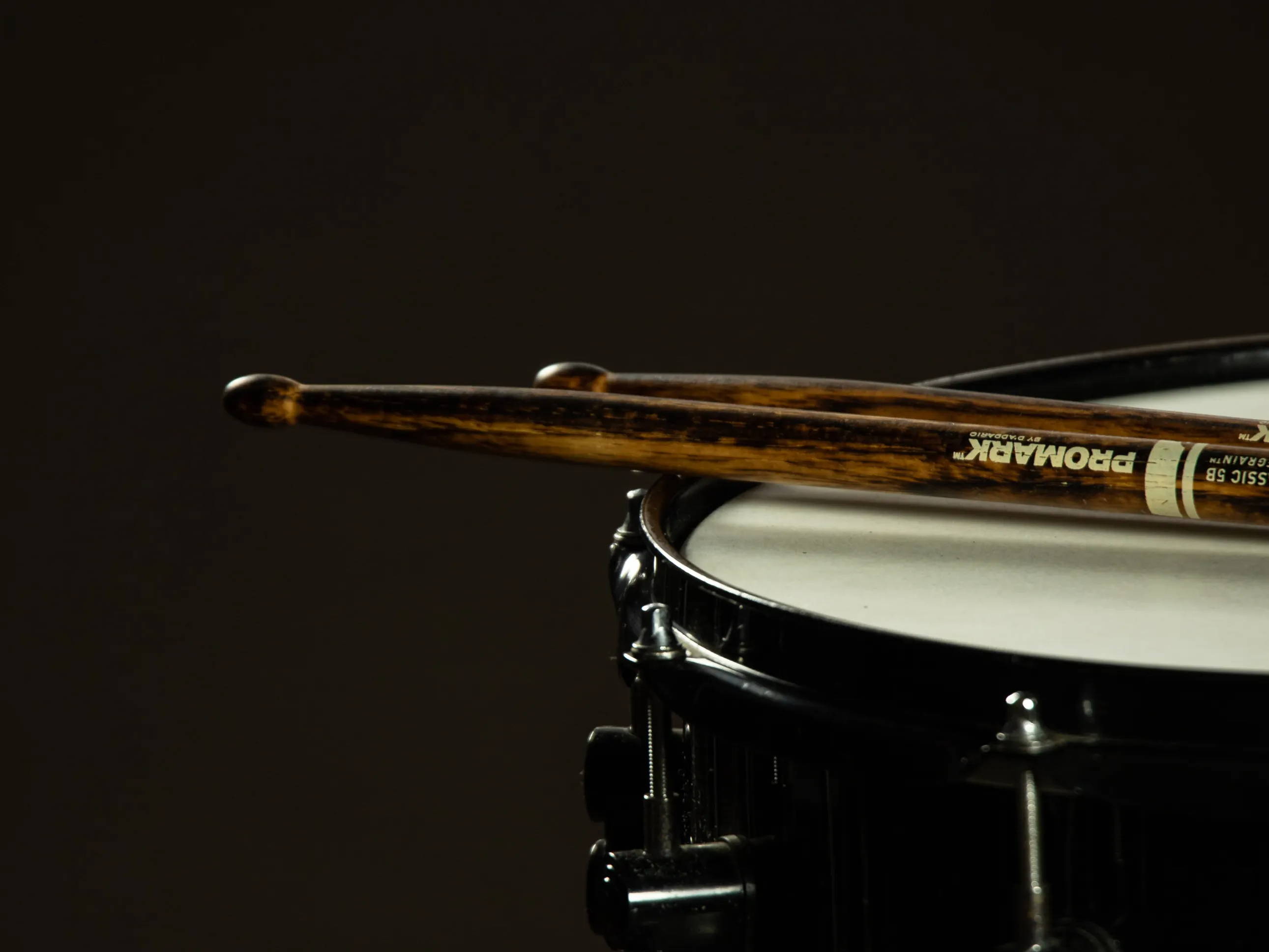 Two drumsticks resting on a drum