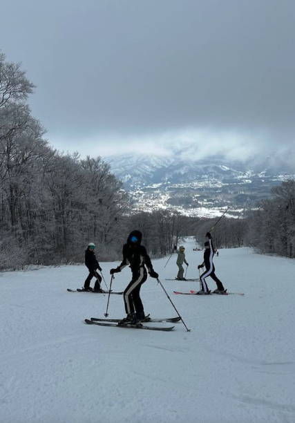 A group of skiers standing on a ski slope