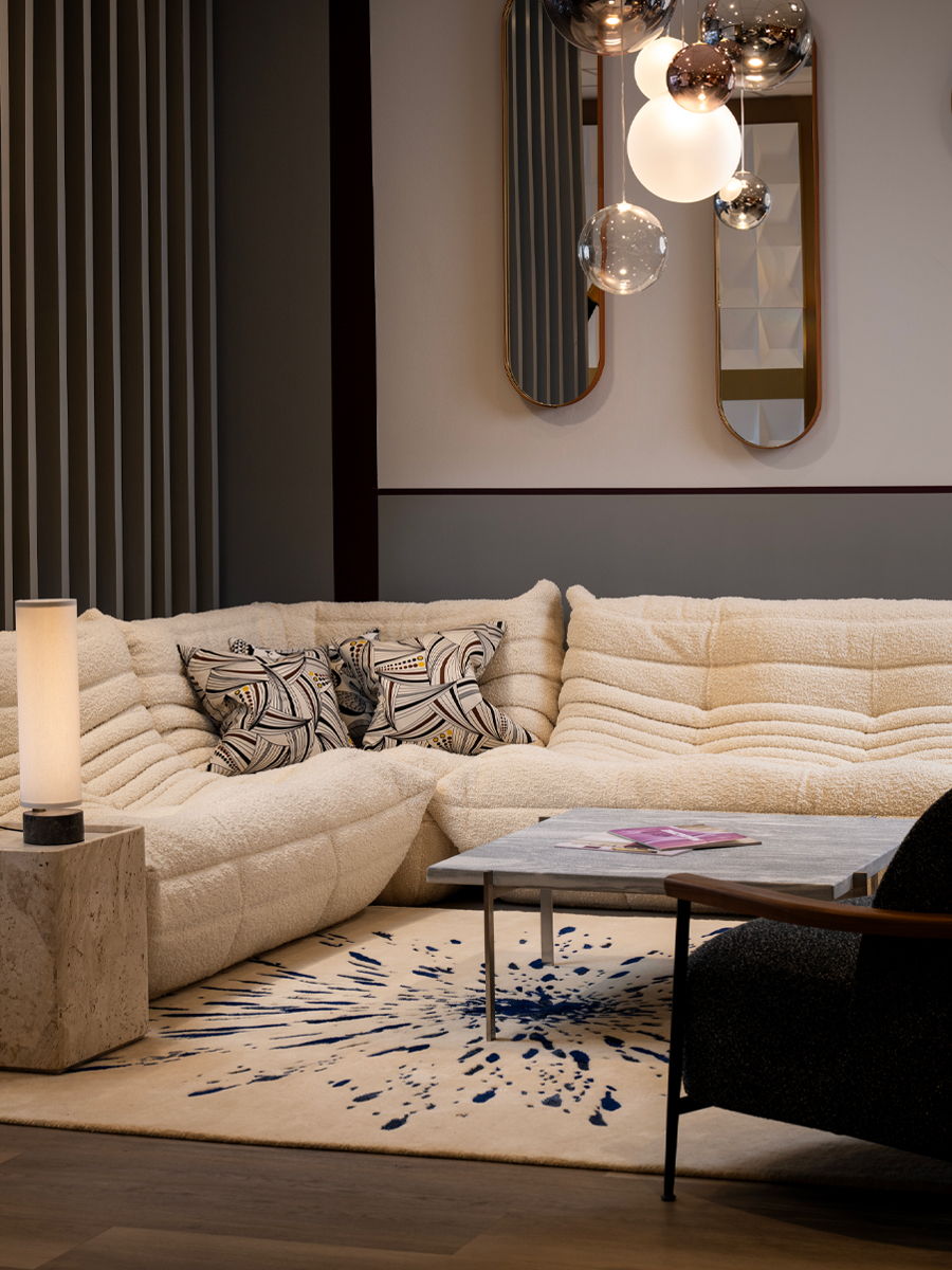 Modern living room setting at Chaplins showroom with a plush Togo sofa by Ligne Roset, coffee table, and stylish decor.