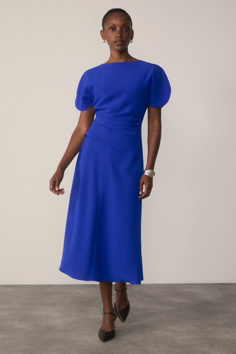 Model wearing vibrant blue Salerno dress