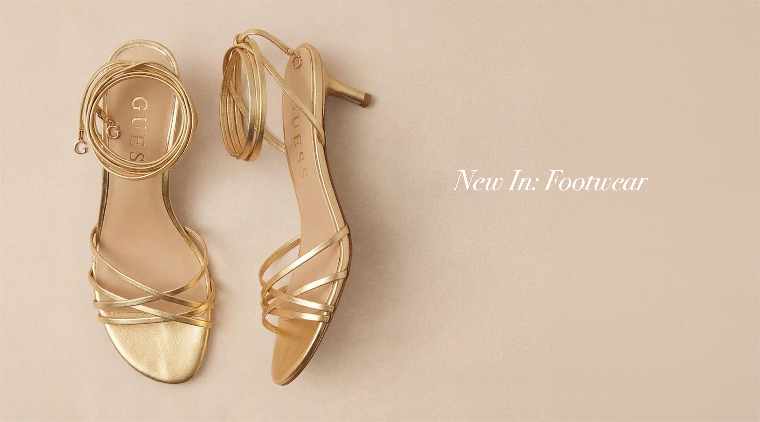 Gold high-heeled sandals on a beige background with text 