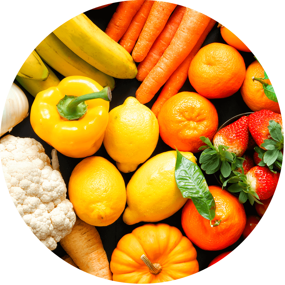 orange and yellow fruits and vegetables arranged on a surface.