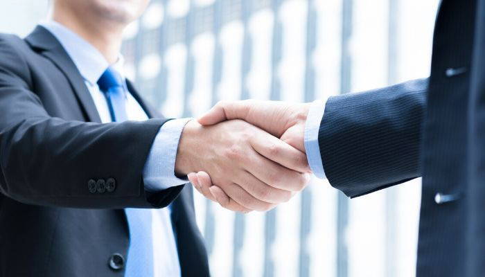 Men in business attire shaking hands
